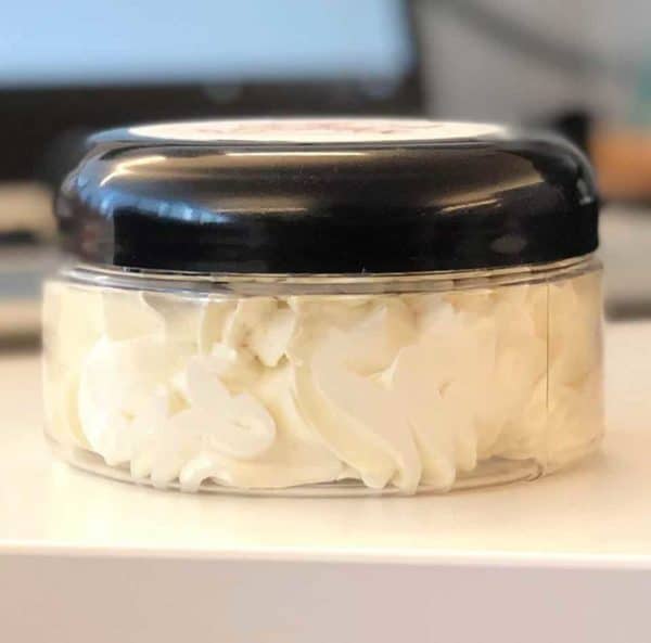 Whipped Shea Butter in a transparent container with a black lid